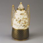 11-inch-high covered jar is decorated with daisies and clouds and is marked with a red crown